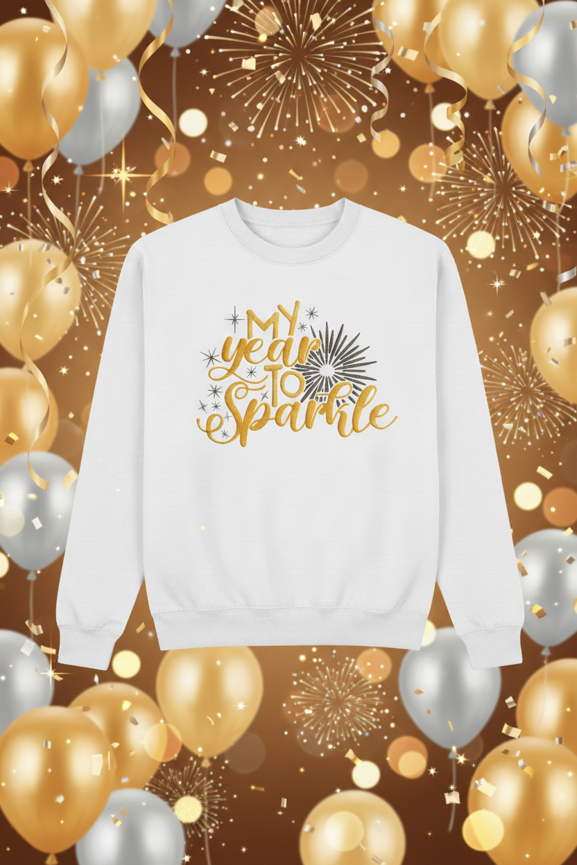 White sweatshirt with My year TO Sparkle gold embroidery on festive New Year's backdrop